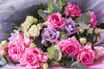 Close-up of a colorful bouquet of flowers. Big pink roses. On a light background, top view, copy space. High quality photo