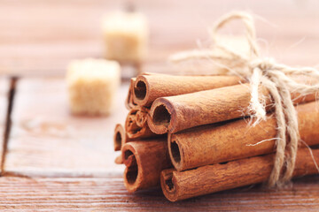 Cinnamon sticks on brown wooden background