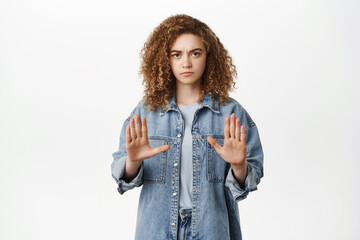 Stop, taboo concept. Young serious woman showing no, prohibit, rejection gesture, forbid smth bad,...