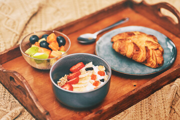 Great food is a lifestyle. Cropped shot of a neatly laid out breakfast arranged on a wooden tray and served in bed at home.