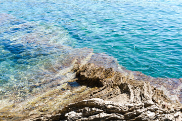 Fototapeta na wymiar Beautiful seascape with a view of the sea and stones. Bright sunny day. Selective focus.