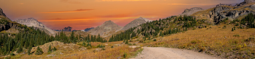 Fototapeta na wymiar A panorama photo of a gravel county road winding through the San Juan mountains near Ouray Colorado