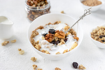 granola,muesli with nuts, raisins and yogurt on a light background ,selective focus
