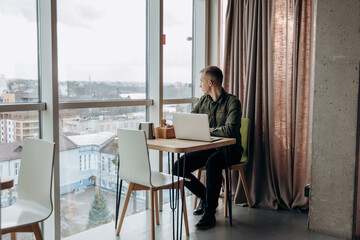 person sitting in cafe with a laptop