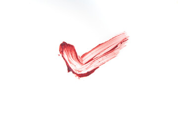 In the form of a tick, a smear of lipstick texture for lips. The red color is highlighted on an isolated white background. An element for beauty cosmetic design. High quality photo