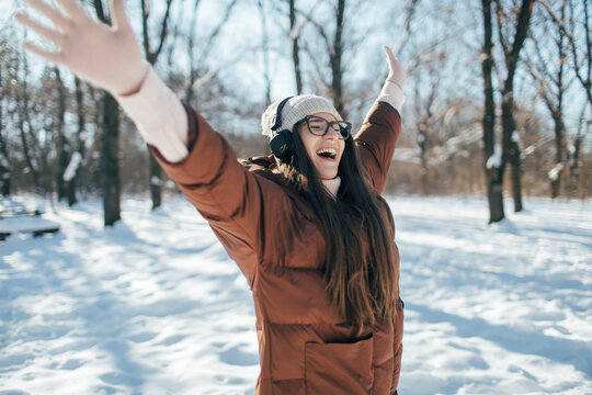 Young pretty woman enjoy winter day with music on headphones 
