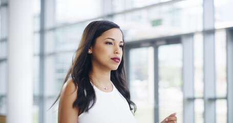 She's got a confident stride. Cropped shot of a confident young businesswoman walking through a...