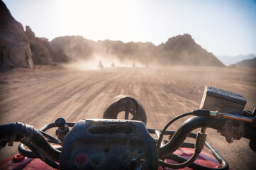 Point-of-view shot from person riding a quad bike in the mountains.