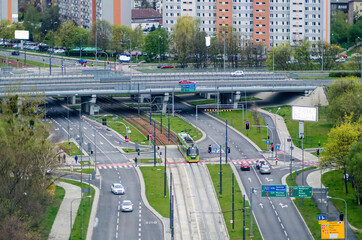 top view in the city at the intersection of two streets, a tram line and a flyover