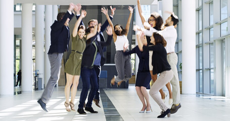 Fototapeta na wymiar We did it. Full length shot of a group of businesspeople celebrating in the workplace.