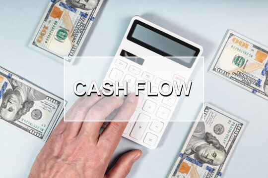 Cash flow concept. Cashflow word on photo with dollars and calculator.