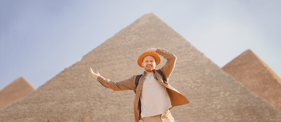 Man tourist walks background of pyramids in Giza Cairo Egypt, sun light travel banner