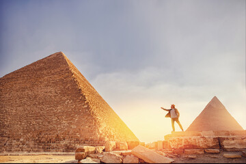 Travel man in hat stand background Egyptian pyramid sunset Giza Cairo, Egypt