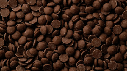 Milk chocolate chips top view. Confectionery concept