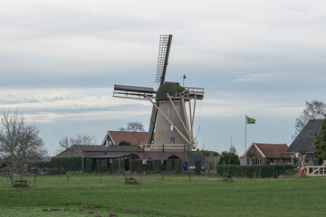 Fototapeta na wymiar old dutch windmill in a little village in the country