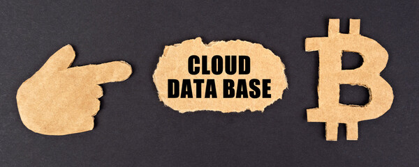 On a black background, cardboard figures of bitcoin and a hand pointing to a sign with the inscription Cloud data base