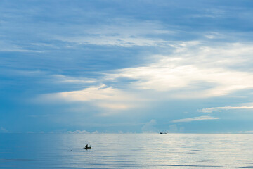 Local fisherman on fishing boat at sunrise scenery.