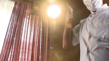 Annonymous Dentist Holding an Old Dental Light Ready to Examine a Patient. Close Up. 4K Resolution.