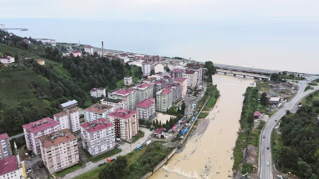 Aerial footage of Cayeli city in Turkey with mountain river disembogue in Black sea. Cityscape