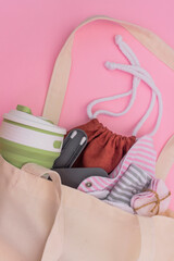 Silicone ear sticks, collapsible silicone mug, Reusable Menstrual Pad, reusable cotton pads, mesh bag for shopping. Zero waste concept. Picture with copy space