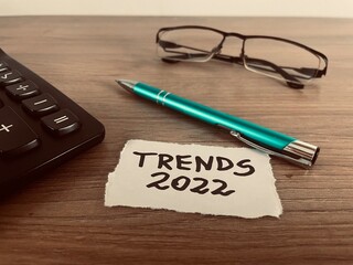 Trends 2022 text with pen, calculator and glasses, business concept