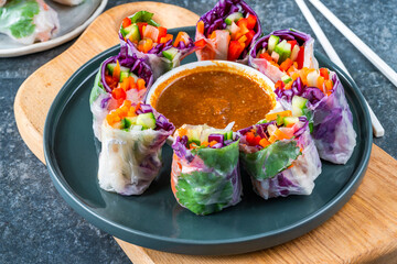 vietnamese vegetarian spring rolls with carrot, cucumber, red cabbage and spicy sauce. Healthy eating