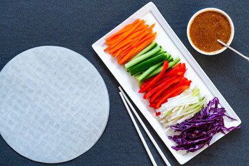 Ingredients for vegan vietnamese spring rolls with carrot, cucumber, red cabbage, spring onions and...