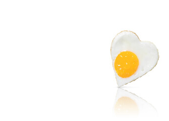 Fried egg (fried egg) in the form of a heart, isolated on a white background with reflection. A place to copy.