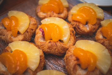 Beautiful multicolored decorated baked sweet tasty candy bar dessert on kids children party with happy people around, catering banquet table