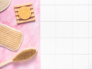 Wellness, spa, beauty eco products flatlay on pink marble and white tiles background. Skin care accessories mock up, top view, copy space.