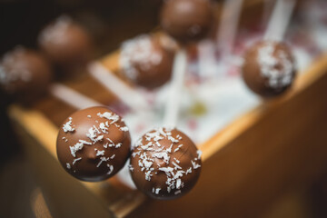 Beautiful multicolored decorated baked sweet tasty candy bar dessert on kids children party with happy people around, catering banquet table