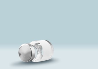 COVID-19 VACCINE for new strain. Ampoule on an abstract light background. Concept new variant of coronavirus