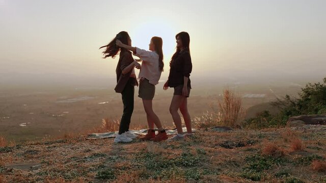 girl friend group Asians blogger standing and caper enjoying the beauty of nature in the evening sunset and shoot video from their action cams to show off to their friends in social media,freedom conc