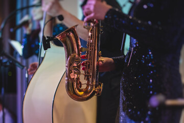 Concert view of a female saxophonist, professional saxophone player with vocalist and musical...