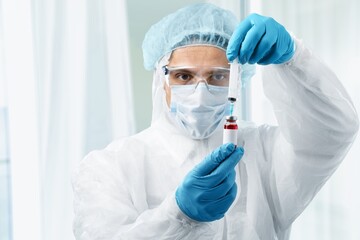 Doctor or scientist filling a syringe with liquid vaccines booster. covid-19 coronavirus, Vaccination