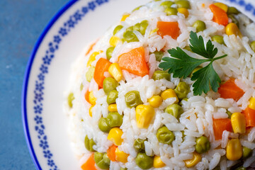 Delicious vegetable rice pilaf with green peas, carrots and sweet corn (Turkish name; sebzeli pilav)