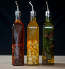 Extra virgin olive oil seasoned with red pepper, garlic and rosemary with olives