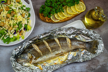 Oven baked trout in foil and salad. 