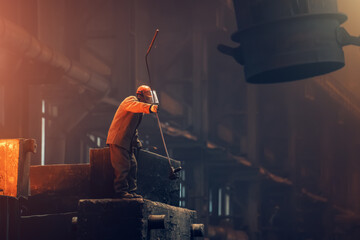 Foundry worker in metallurgy plant after iron cast, heavy industry.