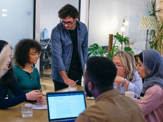 UK, London, Coworkers having meeting in modern office