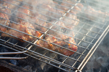 pork ribs in tomato honey sauce on an old grill in the garden. There is a concept on the street,healthy cooking of barbecue meat
