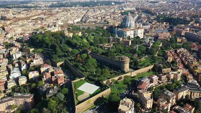Aerial drone video of Saint Peter's gardens of world's largest church -Basilica of St. Peter's, Vatican and iconic Capella Sistine, Rome, Italy