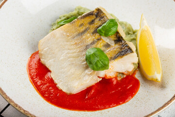 Restaurant dish. Cod fillet with sauce.