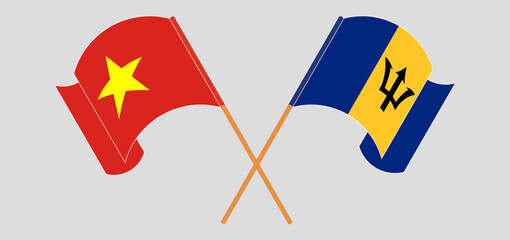 Crossed and waving flags of Vietnam and Barbados