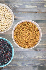 three ceramic bowls with various healthy grains. The concept of natural healthy food. Grains beans close up