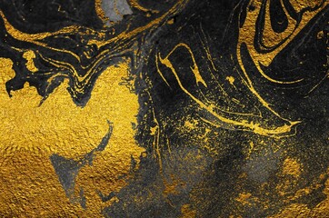 Golden swirl, artistic design. Suminagashi – the ancient art of Japanese marbling. Paper marbling is a method of aqueous surface design. Black and gold paper texture. 