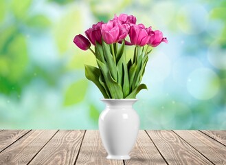 Autumn still life with garden flowers. Beautiful bouquet in a vase on wooden table.