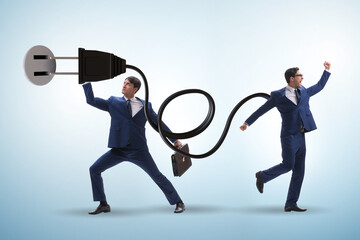 Businessman being powered by electric power