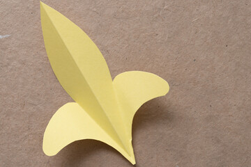 paper fleur-de-lis or fleur-de-lys shape on plain brown paper