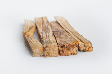 Palo Santo bars close-up and copy space. Ritual cleansing with sacred ibiocai, meditation, aromatherapy with incense and candles..